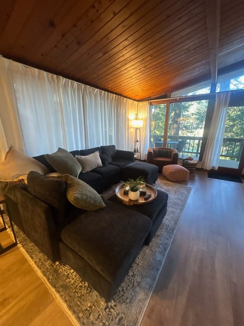 Cozy cabin-style lounge with forest views and private deck access