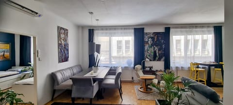 Bright open-plan lounge with dining area, large windows, and stylish decor