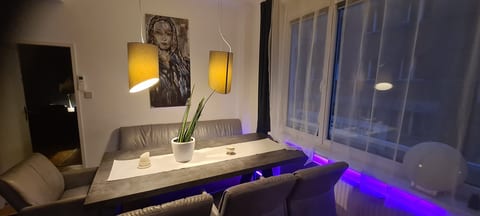 Modern dining nook with ambient lighting and large windows