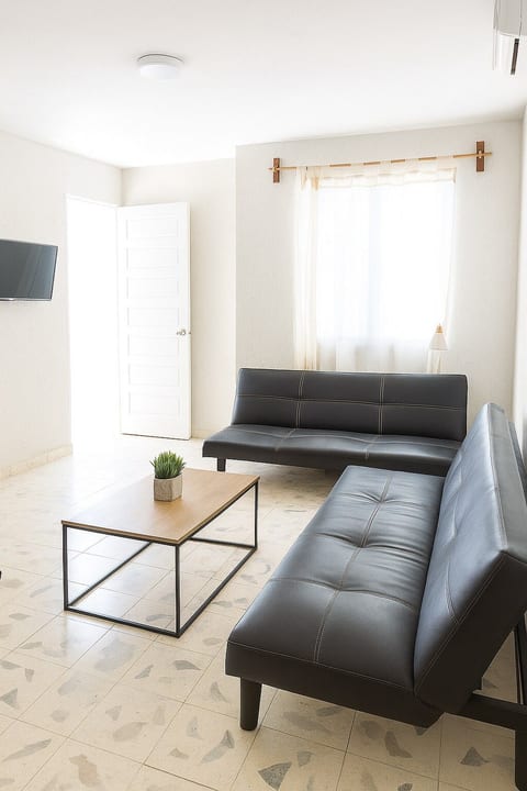 Spacious living room with natural light and plenty of seating to unwind.