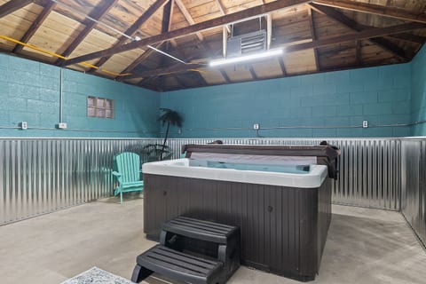 Indoor hot tub room in detached garage.