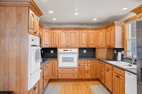 Spacious kitchen featuring natural wood cabinets, built-in oven, and ample prep space—perfect for family meals or group stays.