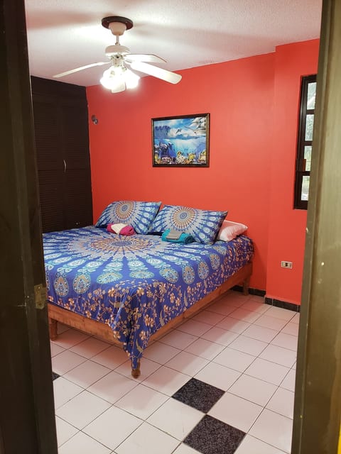 Bedroom with king bed, A/C, and natural light.