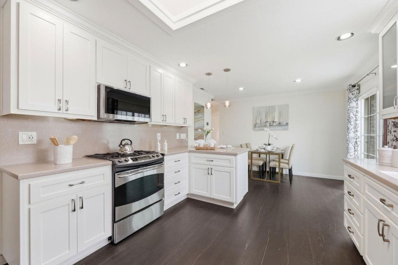 Bright modern kitchen with island, dining space, and elegant finishes