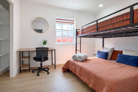 Comfort meets functionality: A versatile bedroom with a workspace, perfect for relaxing or working with ease.
