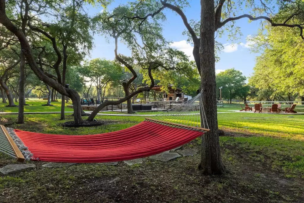 Hammock where you can unwind and admire the trees above. - Main House at Whispering Oaks Estate - Dripping Springs