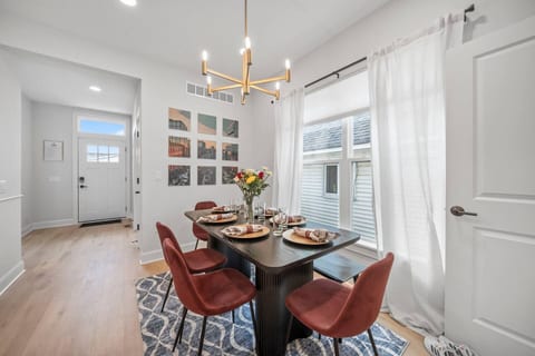 Dining table, which is part of the open concept kitchen and living room area.