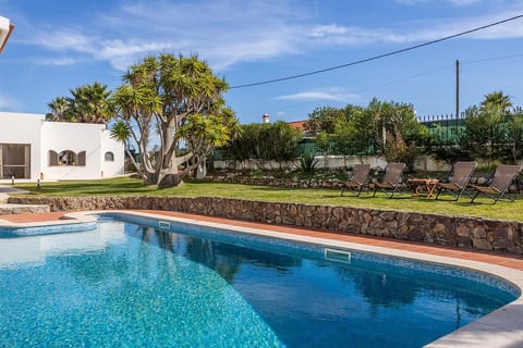 The propertie's shared pool and garden area with the Lodge at the left