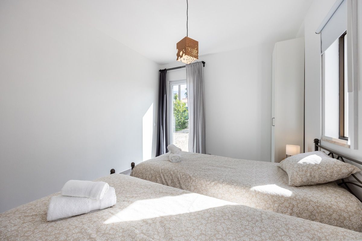This bedroom also features a large door that can tilt for ventilation or open for access to the outside.