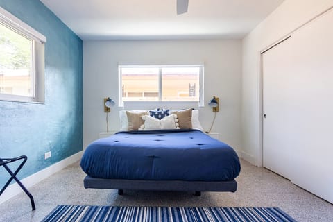 Rest & recharge in Hollywood, Florida! This cozy bedroom with deep blue bedding, soft lighting & modern accents is perfect for couples, solo travelers, or long-term guests seeking a peaceful, well-designed space to unwind and feel at home.