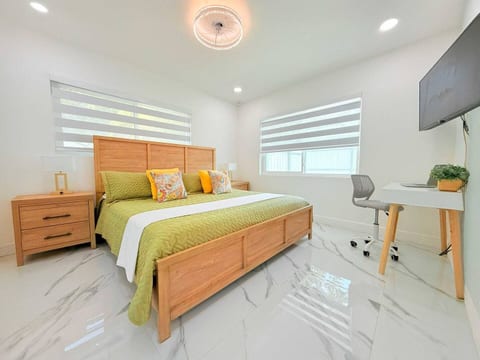 King bedroom with wood accents—rest easy in style after exploring Fort Lauderdale.