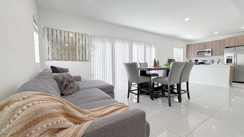 Bright living and dining area—spacious, modern design for gathering and relaxing.