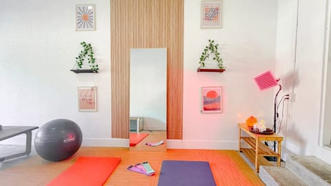 Wellness room with red light therapy—therapeutic healing in a calming pink ambiance.