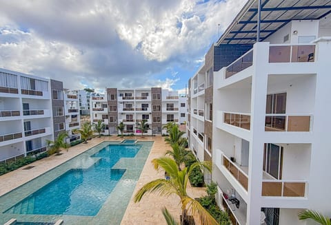 Spacious Oasis: Enjoy stunning pool views and vibrant greenery from your private balcony!