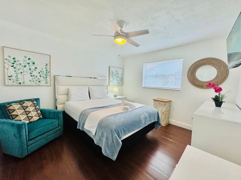 Bedroom with lovely décor—relax in style with soft bedding and a Smart TV.