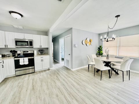 Cook, dine, and unwind in style! This sleek Lakeland, Florida, home features a fully equipped kitchen, and a cozy dining space bathed in natural light. Perfect for families, couples, and remote workers looking for comfort near Lakeland & Clearwater.