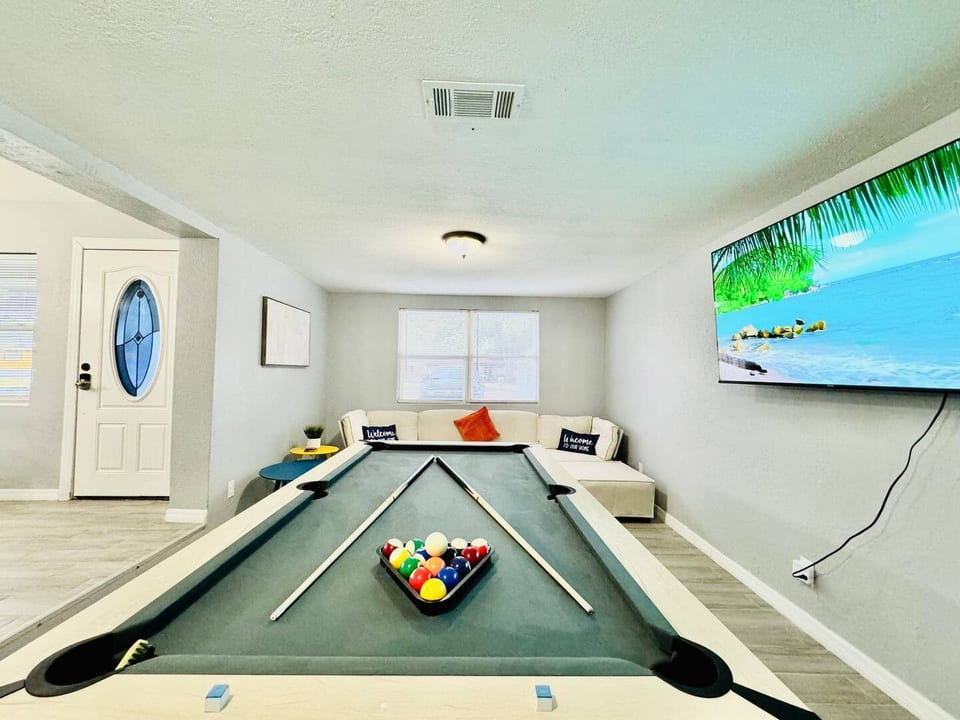 Game night in Lakeland, Florida! This vibrant rec room with a pool table, cozy seating & beach-view TV is perfect for families, friends, or long-term guests seeking entertainment, relaxation, and unforgettable indoor fun.