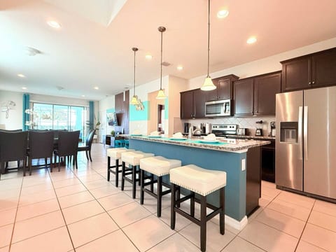Modern kitchen with breakfast bar—cook family meals with resort-style convenience.
