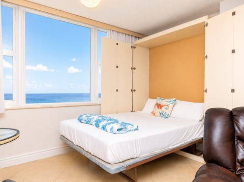 Living room with a Murphy bed, ocean views, and ocean-themed décor—wake up to the sound of waves.
