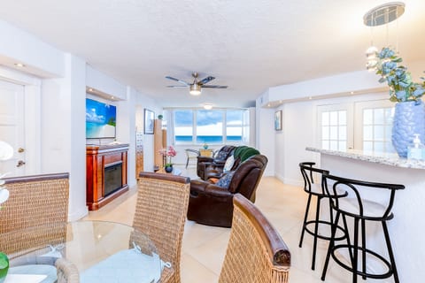 Bright living room with panoramic ocean views—relax in style steps from the beach.