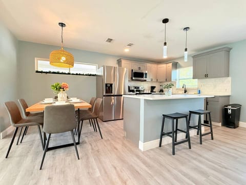 Modern charm in Orlando, Florida! This bright kitchen & dining area with marble island, sleek appliances & cozy table setup is perfect for couples, families, or long-term guests seeking style, comfort, and a welcoming space to gather.