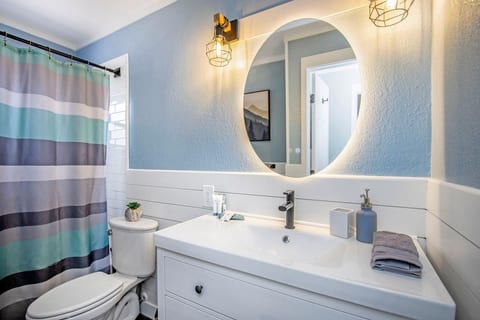 Full bath with light-up mirror and extra supplies.