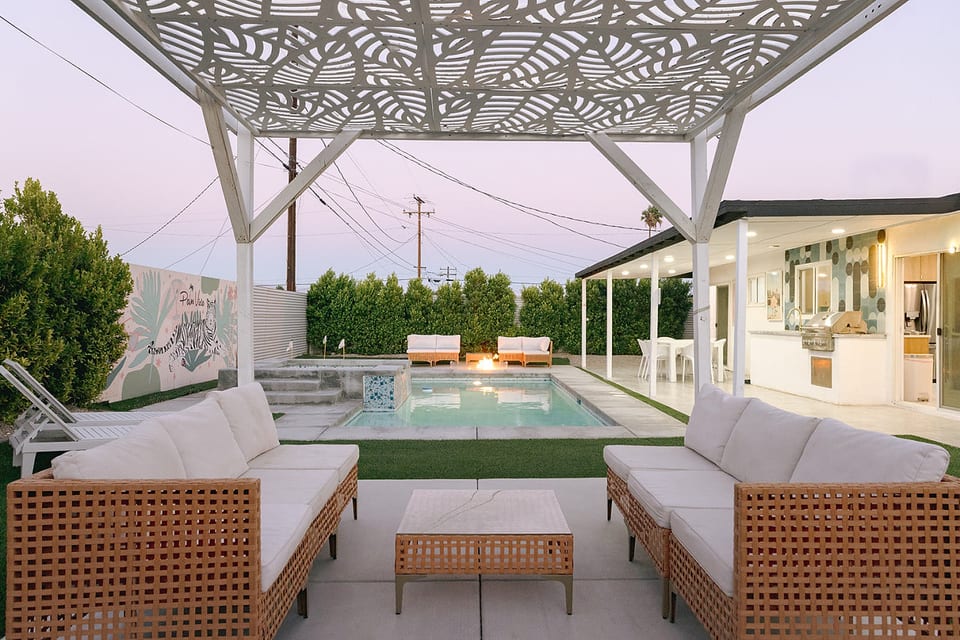 Outdoor dining area under string lights, perfect for laid-back meals and warm evenings.