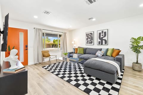 Bright living area w/ cozy seating, bold accents & easy flow for relaxing or gathering together.