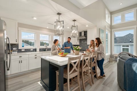 Expansive kitchen & dining area w/ island seating, ideal for meals & gatherings.