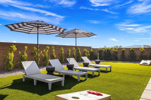 Poolside loungers under a shaded pergola—ideal for afternoon naps, reading, or soaking up the sun.
