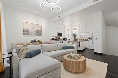 Open living area w/ comfy seating, soft tones & natural light flowing through the space.