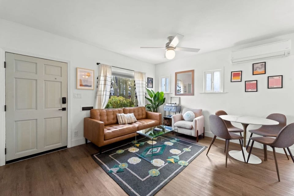 Bright open living area w/ comfy seating, playful accents & a relaxed layout perfect for unwinding after a day out.
