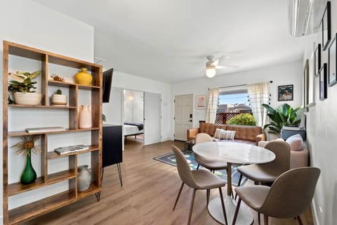 Cozy living space w/ open shelving, warm wood floors & an easy flow into the dining area.