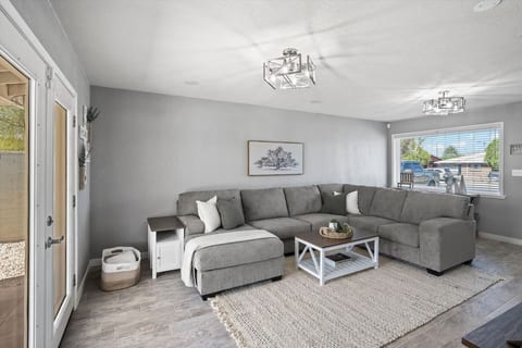Bright living room w/ plush sectional, open layout & easy flow for gathering after a day out.