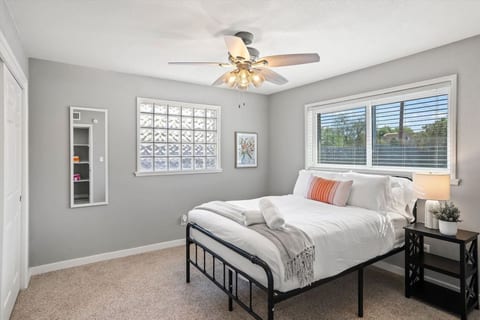Serene bedroom w/ cozy bedding, soft tones & natural light for restful nights.