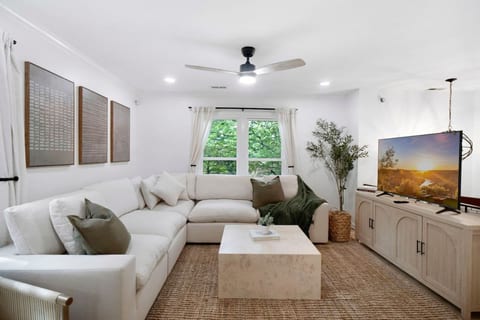 Bright living room w/ cozy seating, natural light, and warm accents—an easy spot to relax after a full day out.