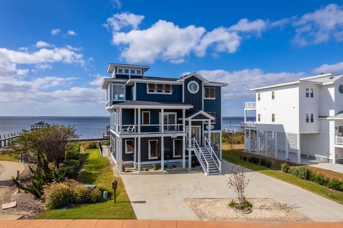 Striking exterior view showcasing the home’s multi-level design & elevated coastal presence.