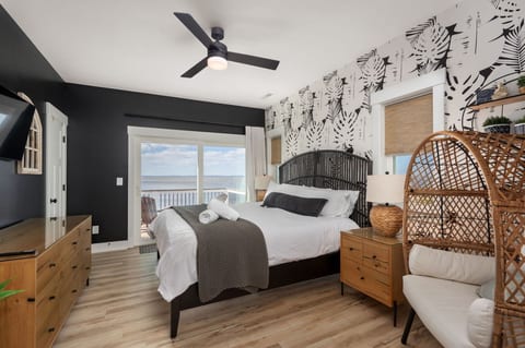 Serene bedroom w/ patterned textiles, soft lighting & a calming coastal vibe for restful nights.