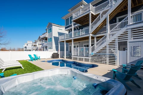 Bright beachfront exterior w/ private pool, sun loungers, & multi-level decks made for laid-back coastal days