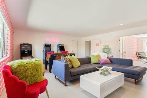 Bright living room w/ playful decor, comfy seating, & colorful accents for laid-back hangouts.
