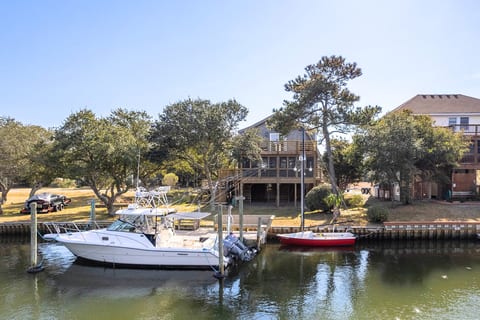Waterfront neighborhood view w/ docks & boats, capturing the relaxed coastal setting.