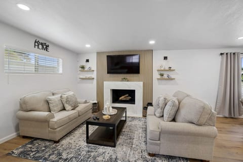 Inviting living room w/ cozy seating, fireplace & warm finishes for relaxed evenings together.
