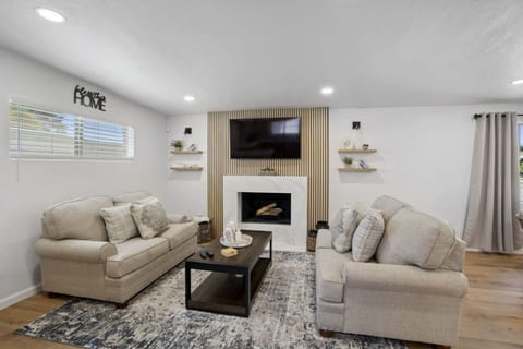 Inviting living room w/ cozy seating, fireplace & warm finishes for relaxed evenings together.
