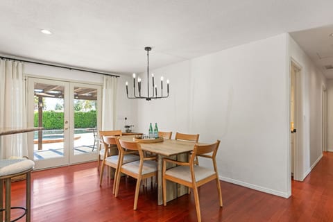 Casual dining area w/ modern table & glass doors that open to outdoor space for easy in-and-out meals.