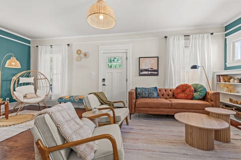 Spacious living area w/ plush sofas, warm decor, & plenty of room to lounge, stream, or spend time together.