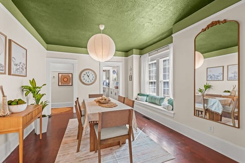 Sunlit dining nook w/ cheerful accents, cozy seating, & windows that make every meal feel light and unhurried.