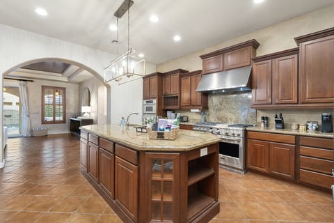 Spacious kitchen w/ ample counters, wood cabinetry & room to gather