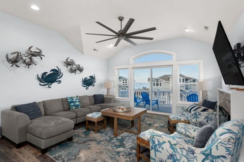 Bright coastal living room w/ plush seating, beachy accents & plenty of natural light