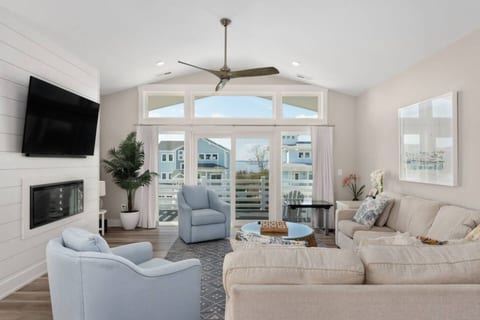 Bright living room w/ soaring ceilings, comfy seating & easy flow to the outdoors.