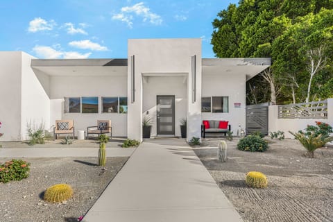Clean-lined exterior entry welcomes you w/ modern design & low-maintenance desert landscaping